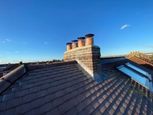 A chimney with new lead flashing on a roof in Basingstoke.