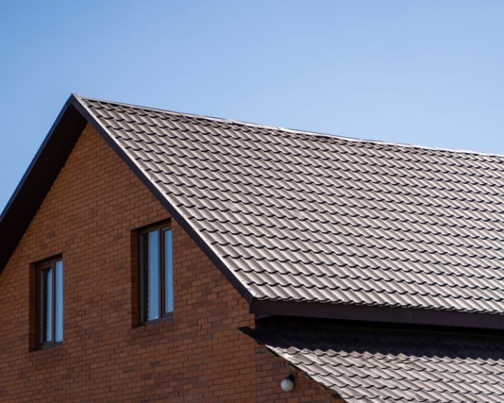 A house with a metal roof that requires the expertise of roofers at a specific location.