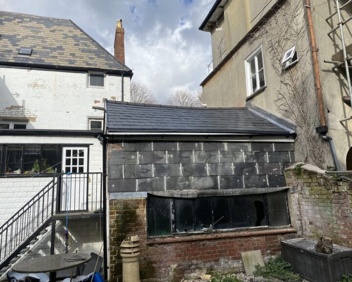 New pitched roof with slate tiles installed on an outbuilding