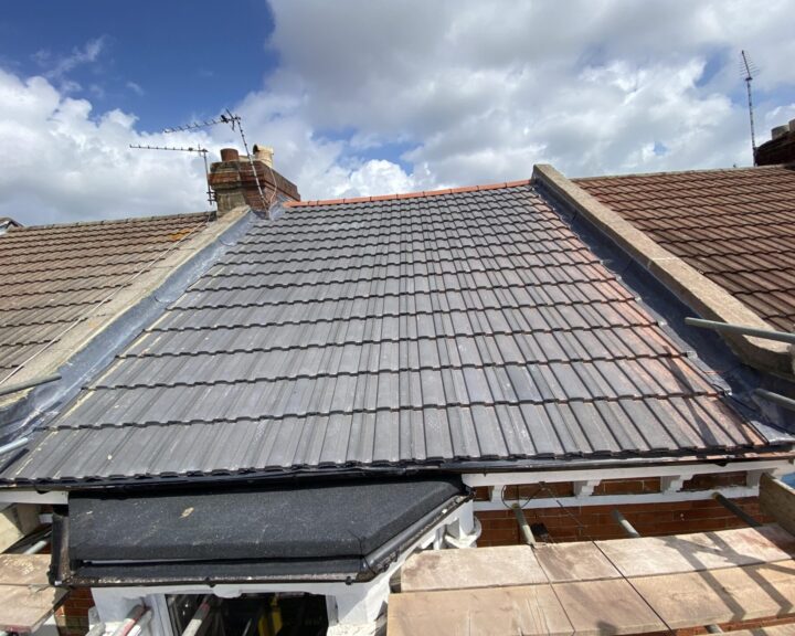 New pitched roof installed with grey slate tiles on a residential roof